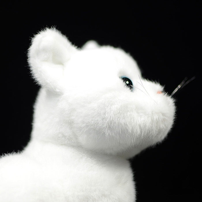Side view of the white cat plush head, emphasizing its realistic fur texture and gentle expression