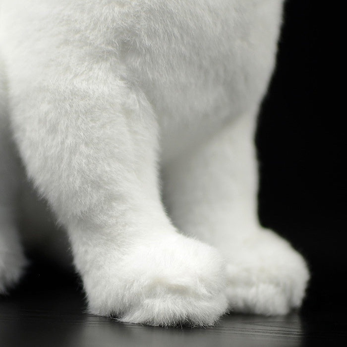 Detailed shot of the white cat plush toy's soft paws, crafted for a lifelike and huggable appearance