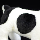 Zoomed-in view of a black spot on the plush toy, showing its realistic pied pattern and texture