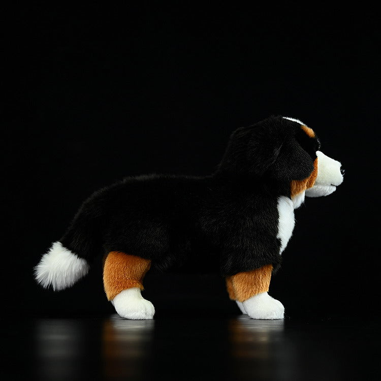 Side profile of a Bernese Mountain Dog plush toy, highlighting its realistic design and adorable build