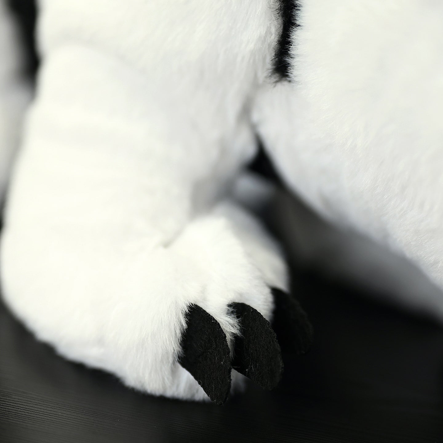 Close-up of Southern Tamandua plush toy's claws, showcasing its lifelike craftsmanship and soft texture