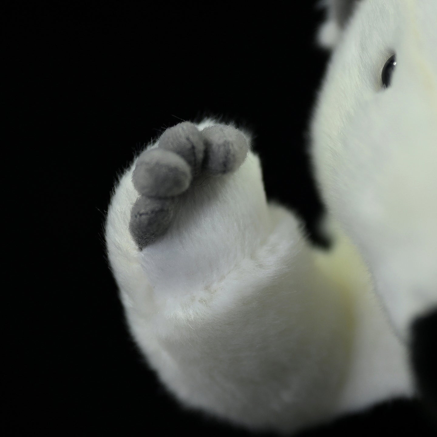 Close-up of a Southern Tamandua plush toy’s paw, showcasing its detailed stitching and soft fabric