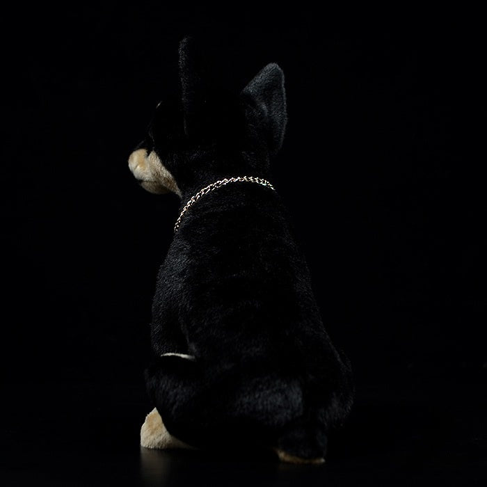 Rear view of a realistic Doberman plush toy, highlighting its sleek black coat and natural posture