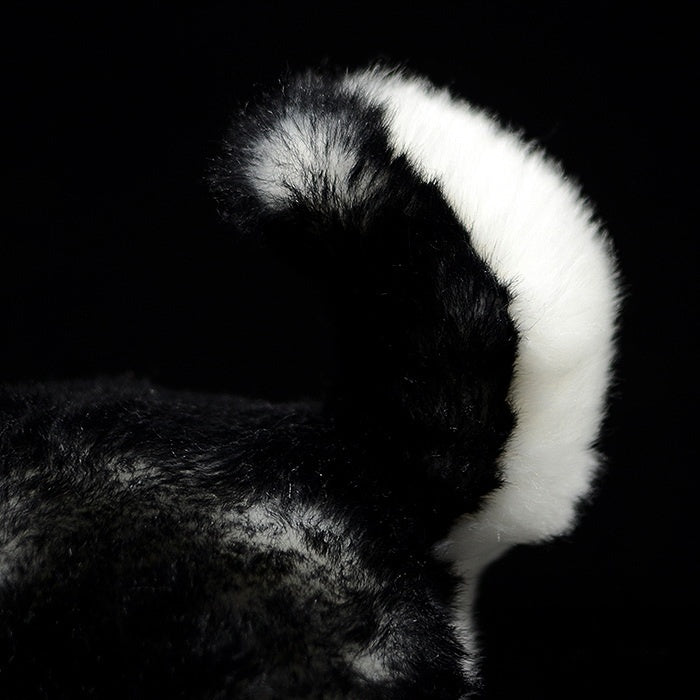 Fluffy tail of a Siberian Husky plush toy, showcasing the lifelike fur texture and attention to detail