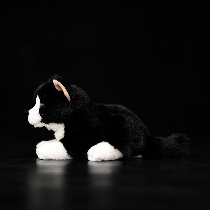 Side profile of a Tuxedo Cat stuffed animal, showcasing its soft fur and realistic sitting pose