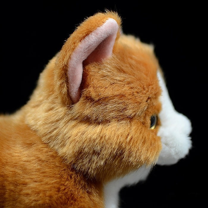 Detailed side view of Orange Tuxedo Cat plush toy’s ear and fur texture