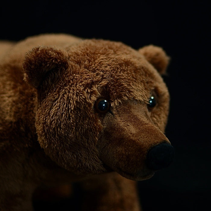 Close-up of a brown bear plush head with detailed eyes, nose, and soft textured fur