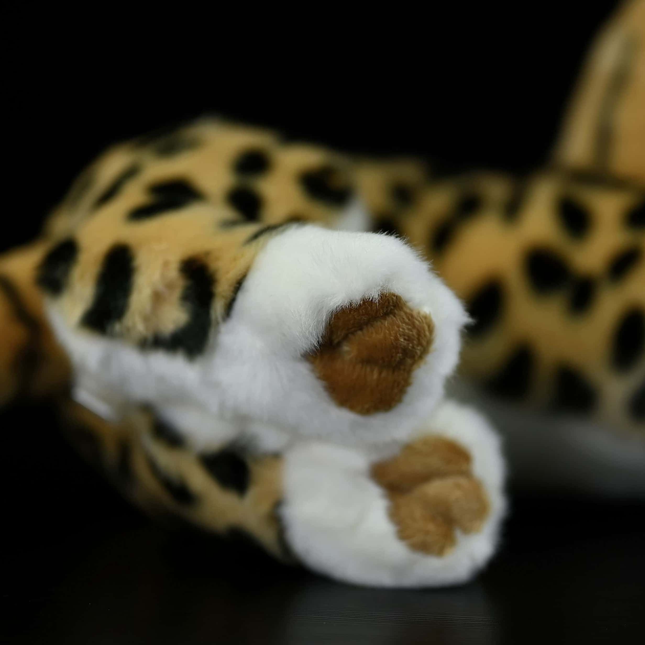 Close-up of the serval cat plush toy’s soft paw, showcasing fine details and lifelike design