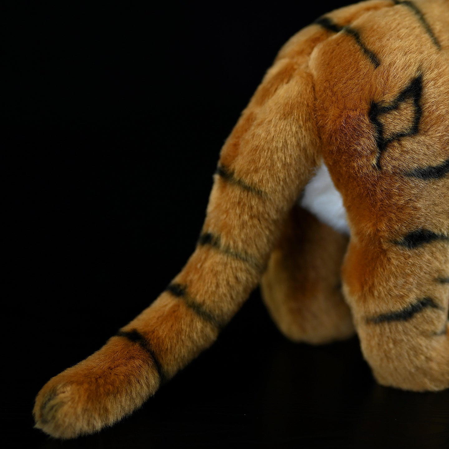 Close-up of tiger plush toy's tail, highlighting its authentic design and realistic detail