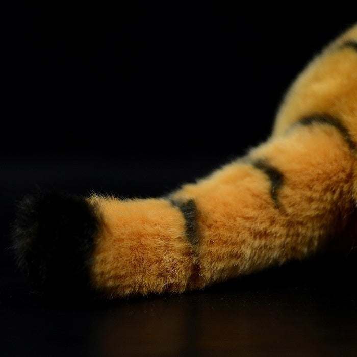 Detailed tiger plush tail with black-striped design, perfect for decor or playtime displays
