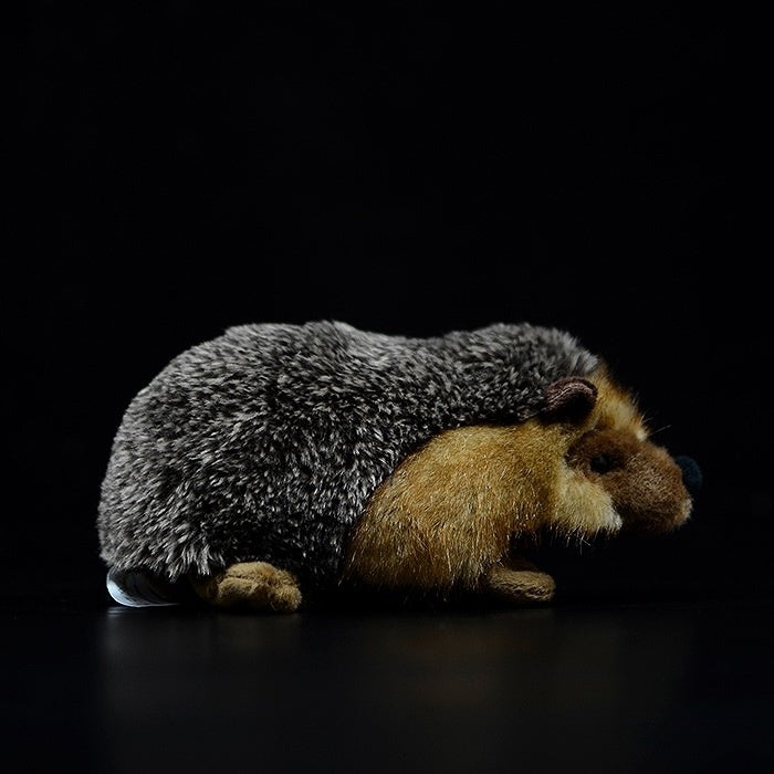 Side profile of a realistic hedgehog plush toy with soft fur and detailed design