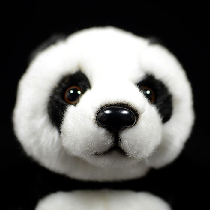 Close-up of a giant panda plush toy's face, featuring lifelike details and adorable eyes