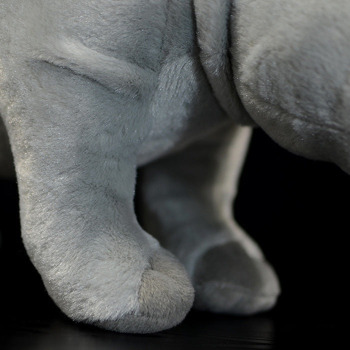Close-up of a white rhino plush toy's feet, showcasing its soft and lifelike design