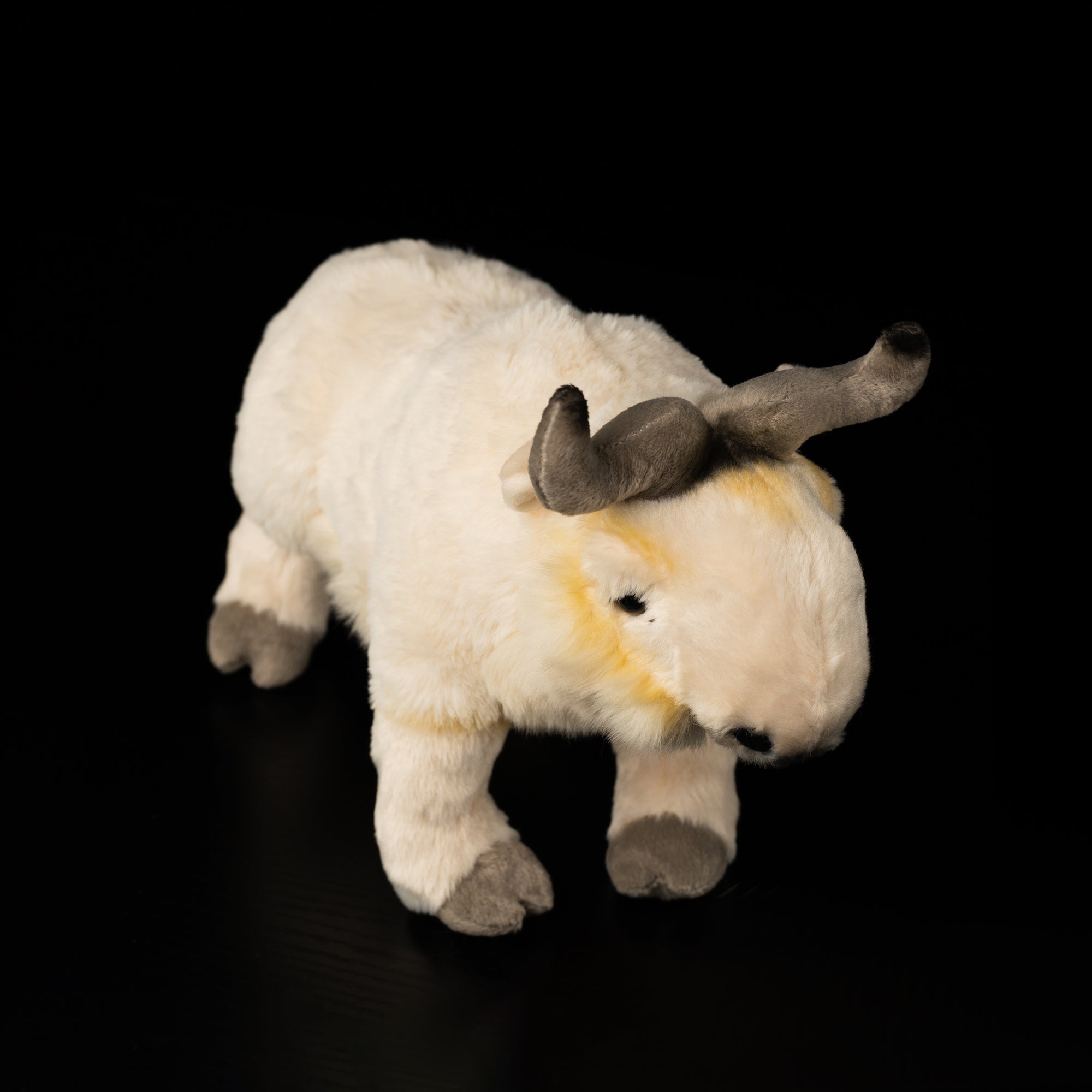 Top-angle view of lifelike takin stuffed animal by SoftDaysLab®, featuring realistic horns and soft plush design
