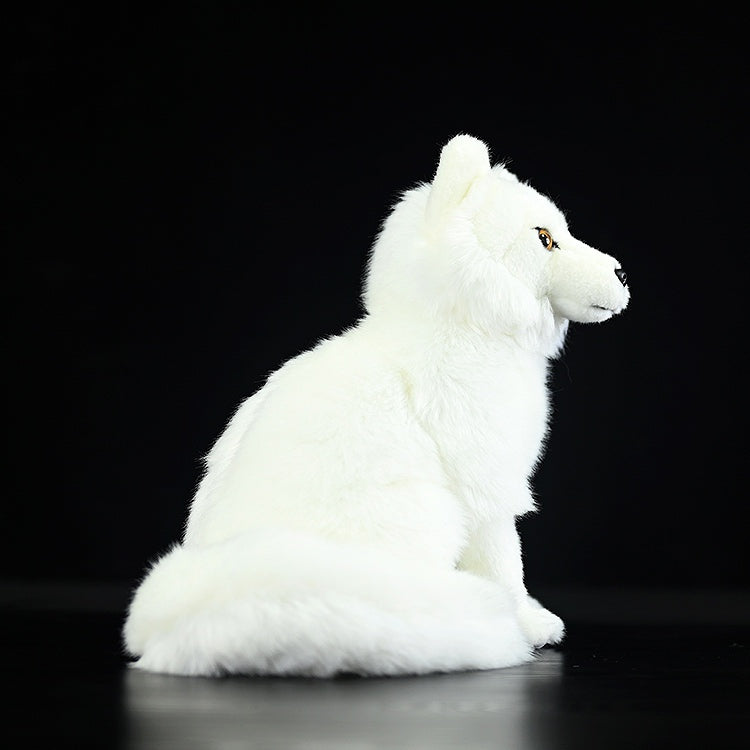 Side view of a cuddly Arctic fox plush toy, showcasing its realistic design and soft texture