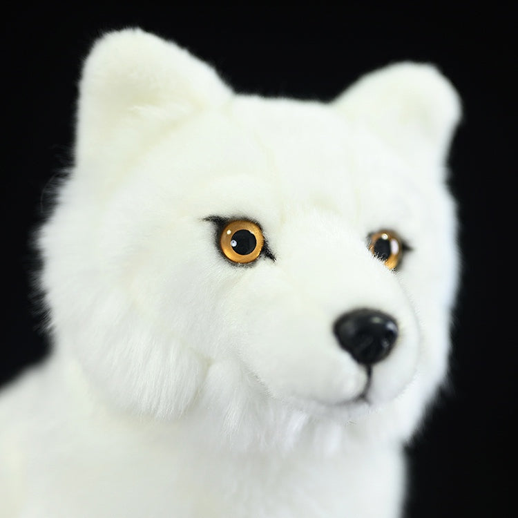 Close-up of the Arctic fox plush toy's face, showing its detailed eyes and realistic nose
