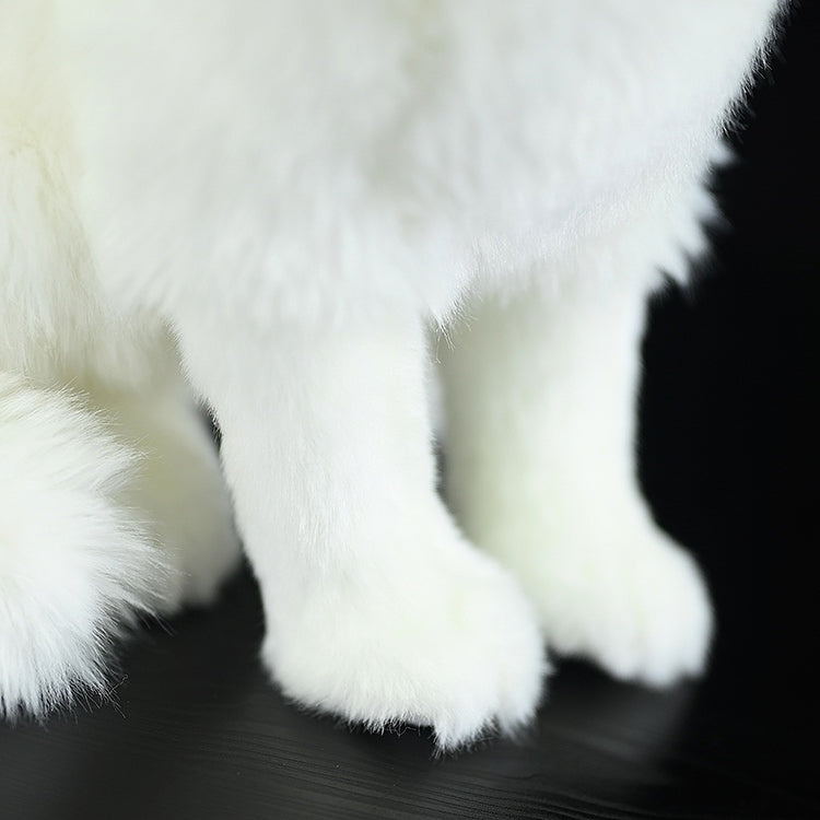 Zoomed-in view of the Arctic fox plush toy's soft paws and fluffy fur texture