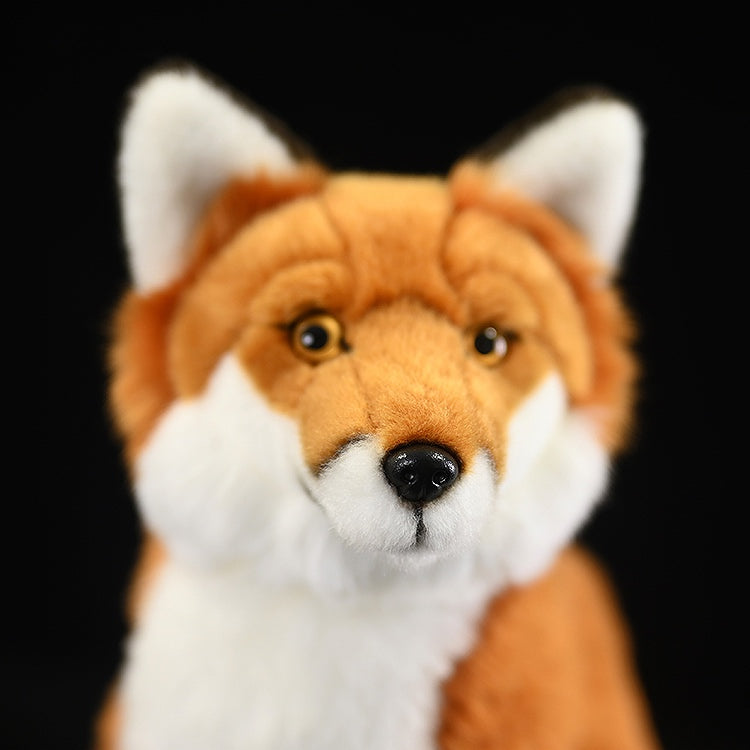 Front view of a red fox plush toy, showcasing its soft orange fur, white chest, and fluffy tail, perfect for wildlife enthusiasts