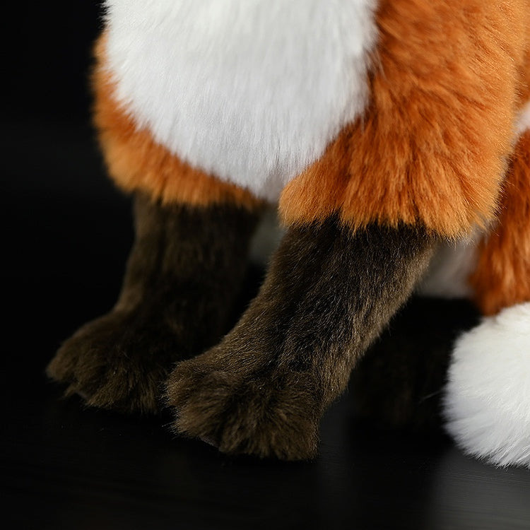 Close-up of the red fox plush’s legs, featuring soft fur and realistic attention to detail