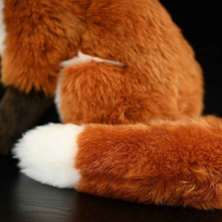 Close-up of the red fox plush’s fluffy tail, featuring vibrant colors and soft, realistic texture