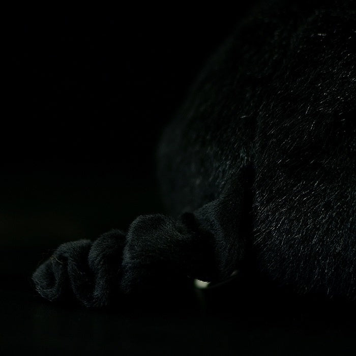 Close-up of the curled tail of black and white pig plush with soft detailing by SoftDaysLab