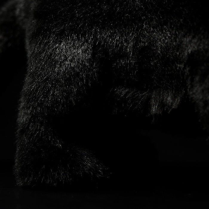 Detailed shot of a black panther plush paw, featuring soft, high-quality fur for a realistic feel