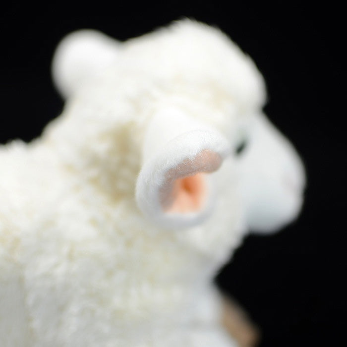 Detailed side view of the sheep plush's ear, featuring its realistic design and soft fabric