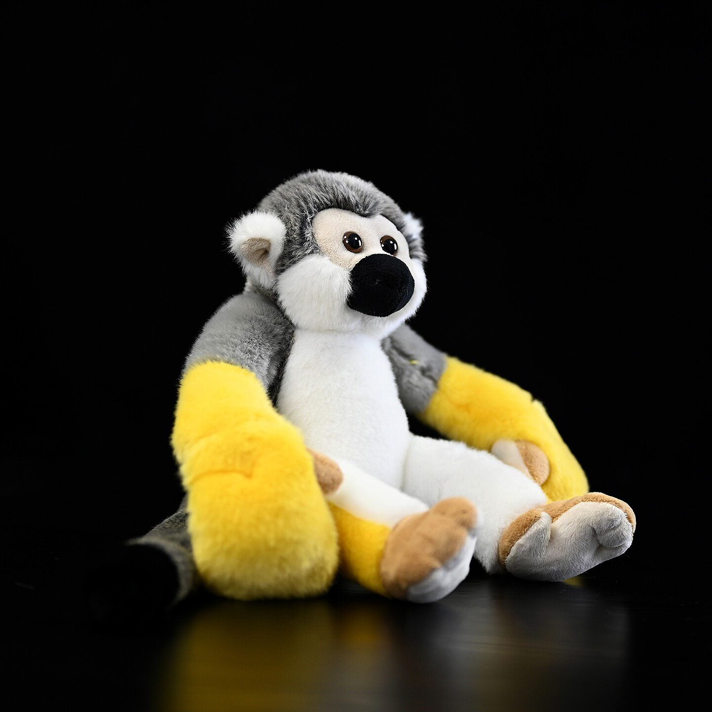 Sitting Common Squirrel Monkey plush with soft yellow arms, perfect for snuggles and display