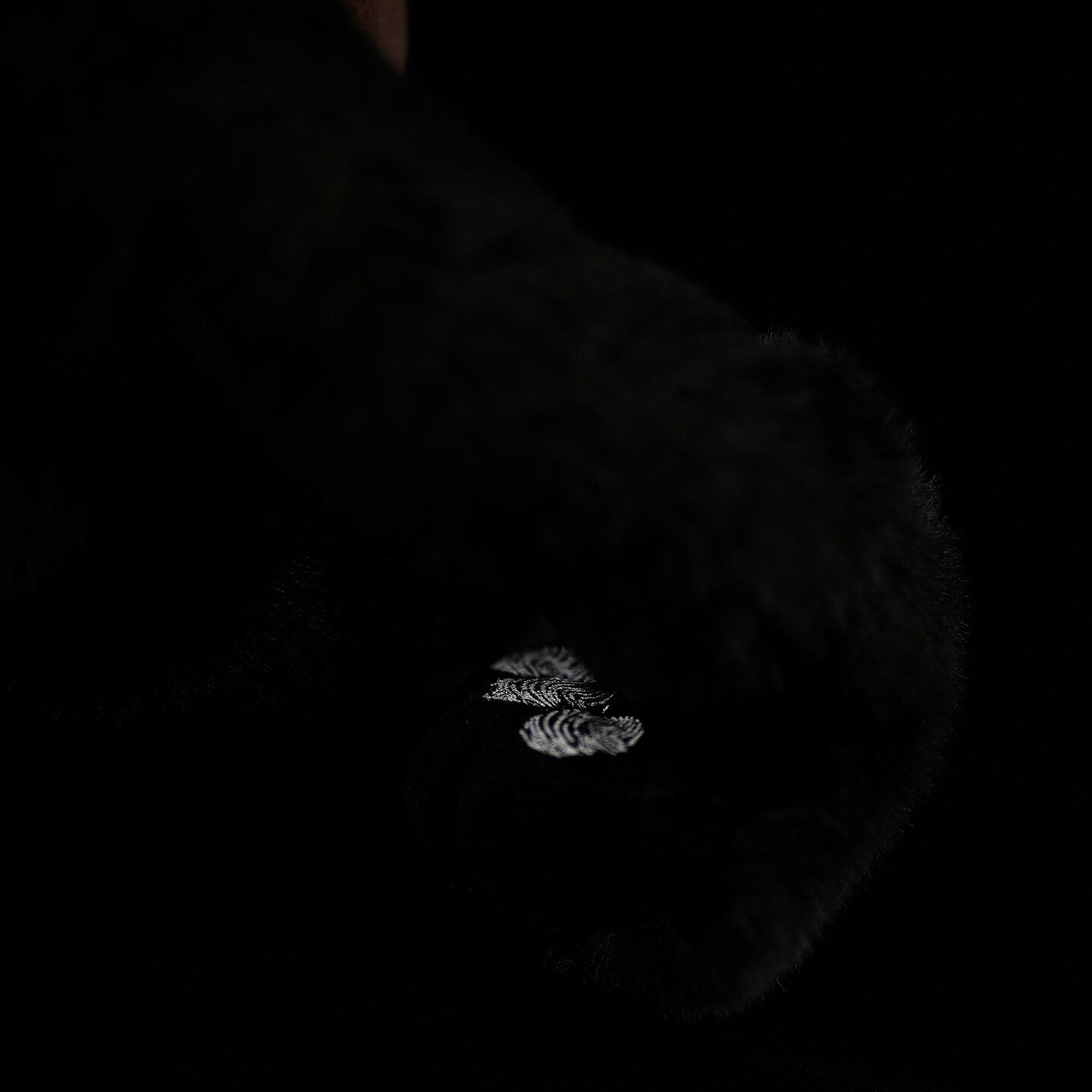 Detailed shot of Siamang Gibbon plush hand, showing intricate stitching and soft premium material