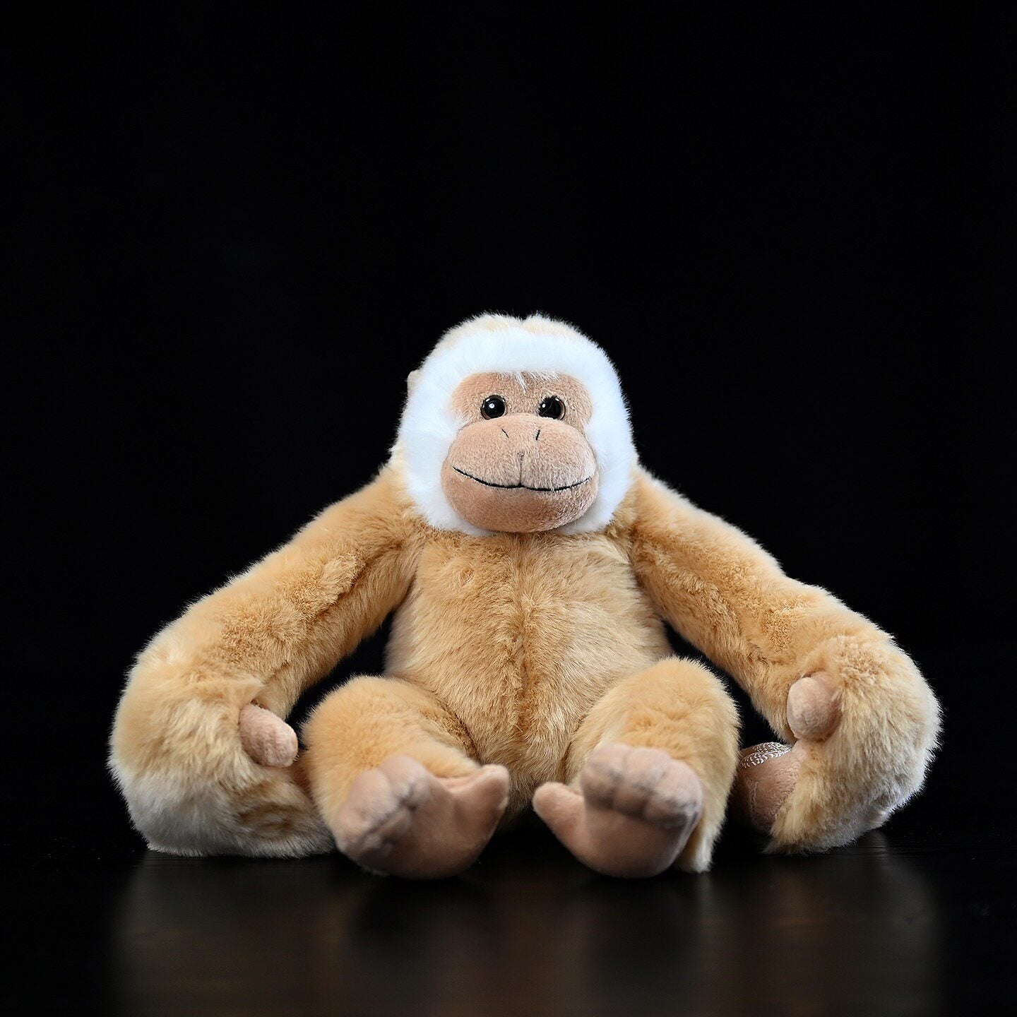 Hanging gibbon plush by SoftDaysLab sitting with long arms, realistic Hylobates lar stuffed monkey
