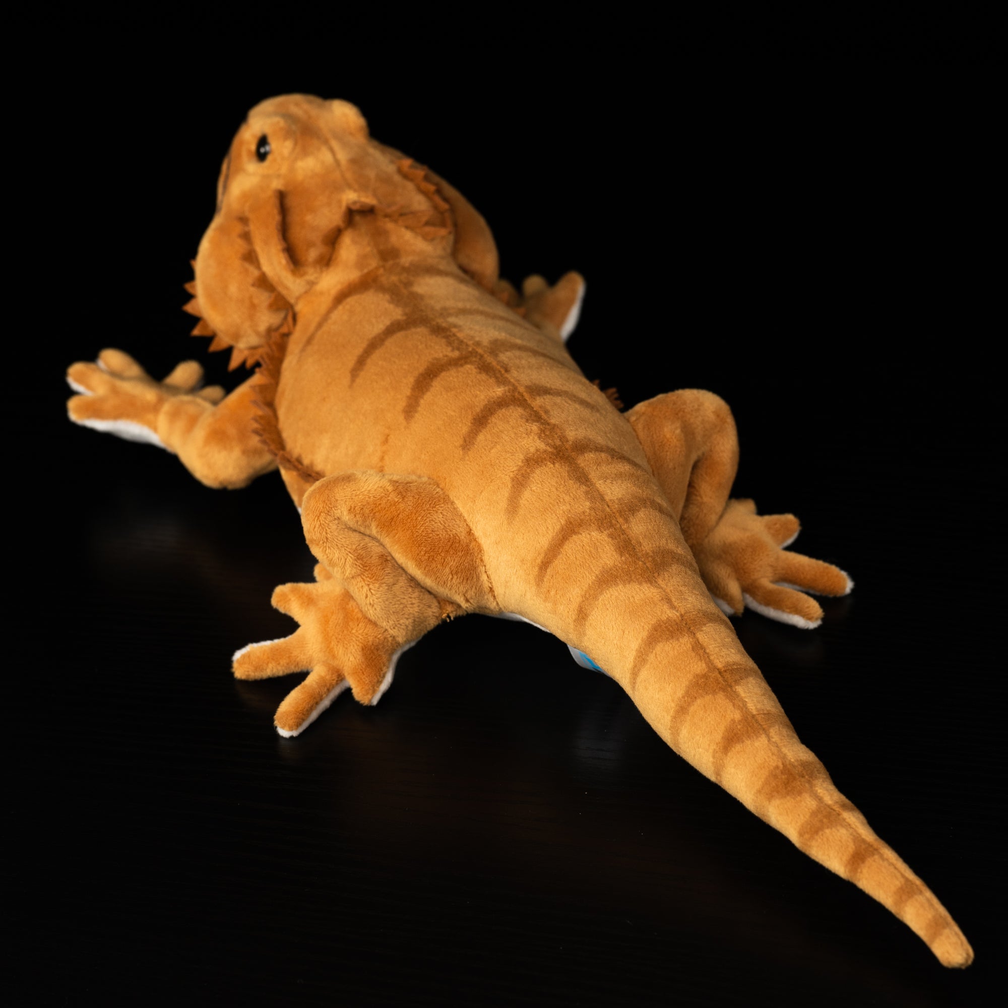 Rear view of realistic bearded dragon plush toy highlighting tail stripes and soft texture by SoftDaysLab
