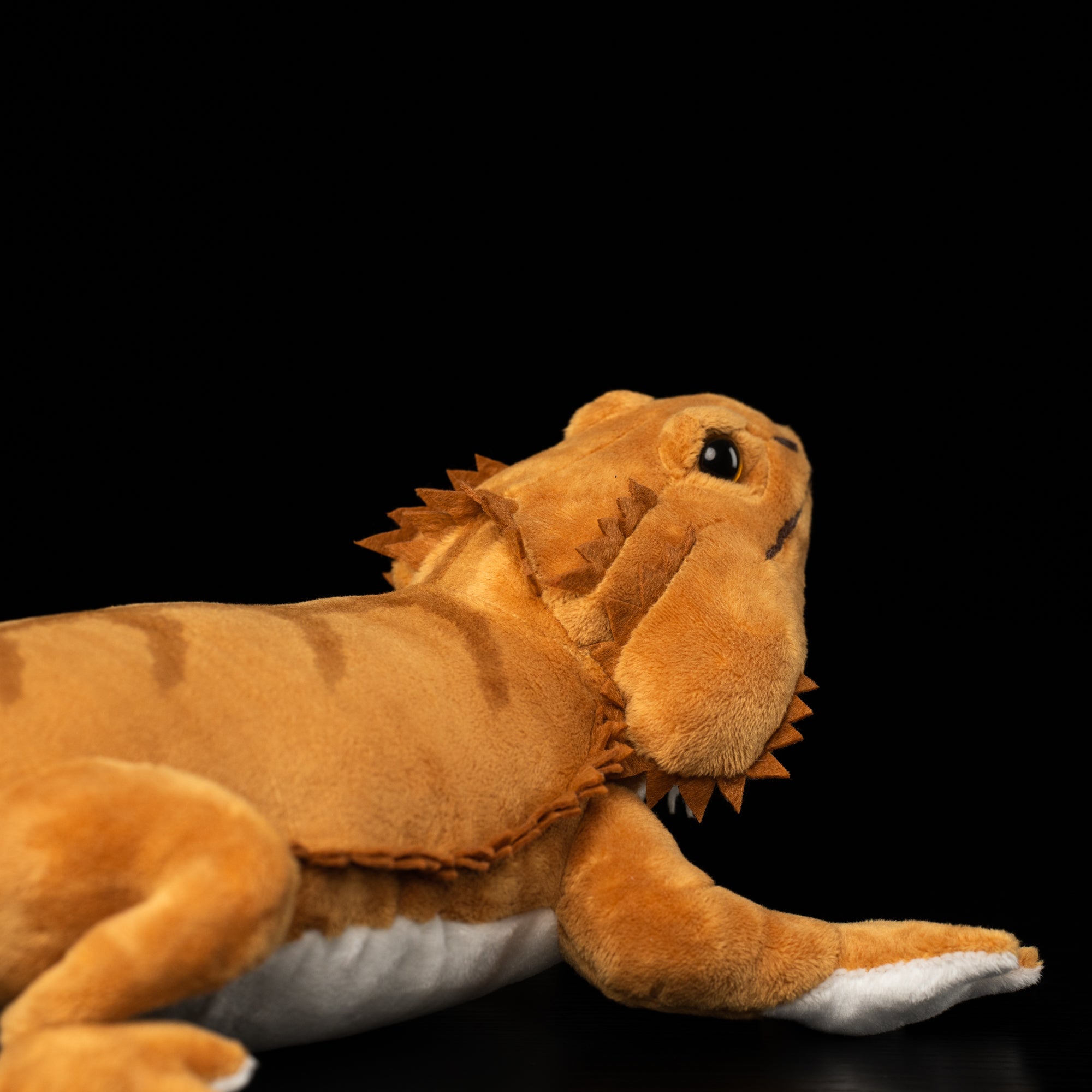 Detailed image focusing on the textured spiny frills on the side of bearded dragon plush toy's head by SoftDaysLab