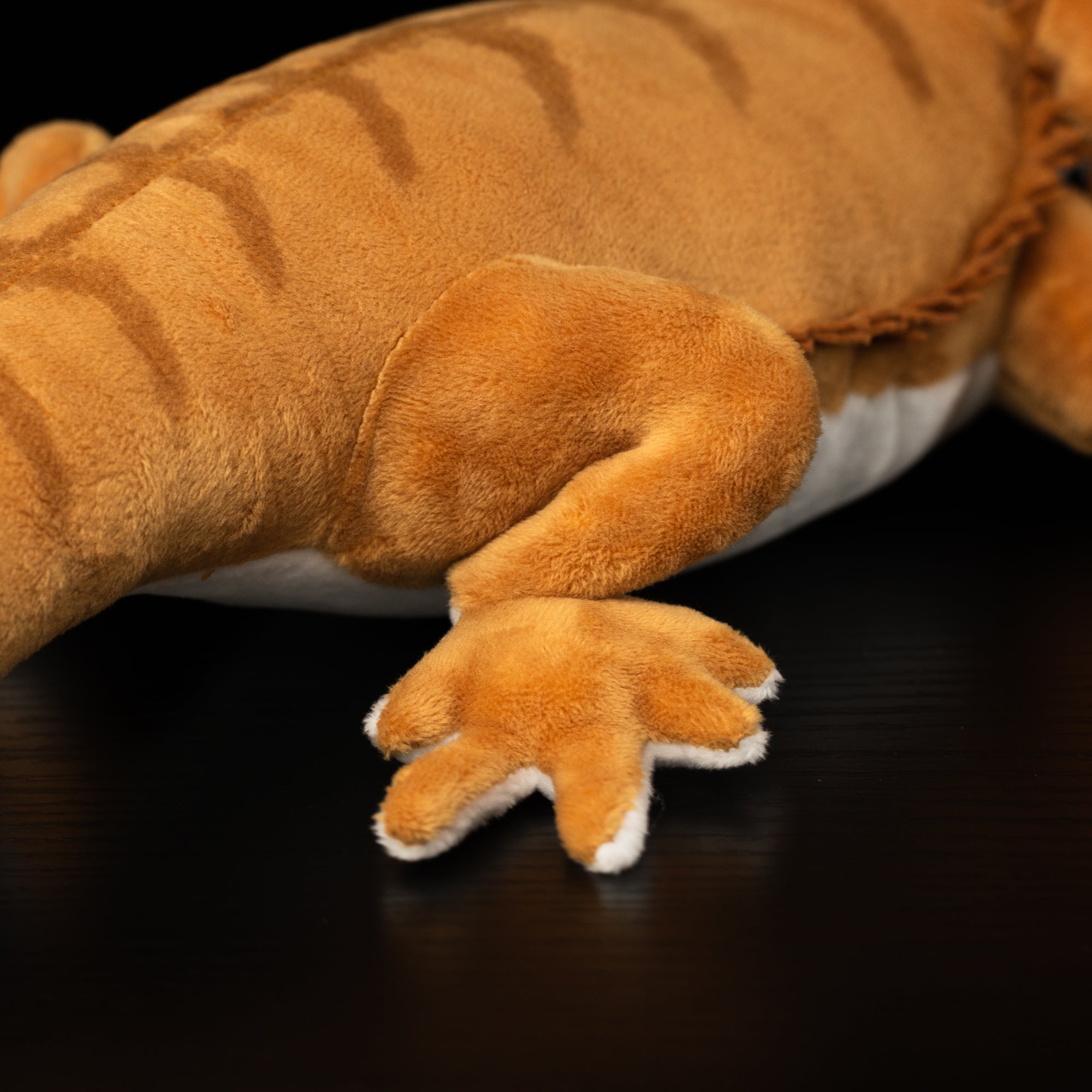 Close-up view of bearded dragon plush toy's clawed foot, showing soft fabric details by SoftDaysLab