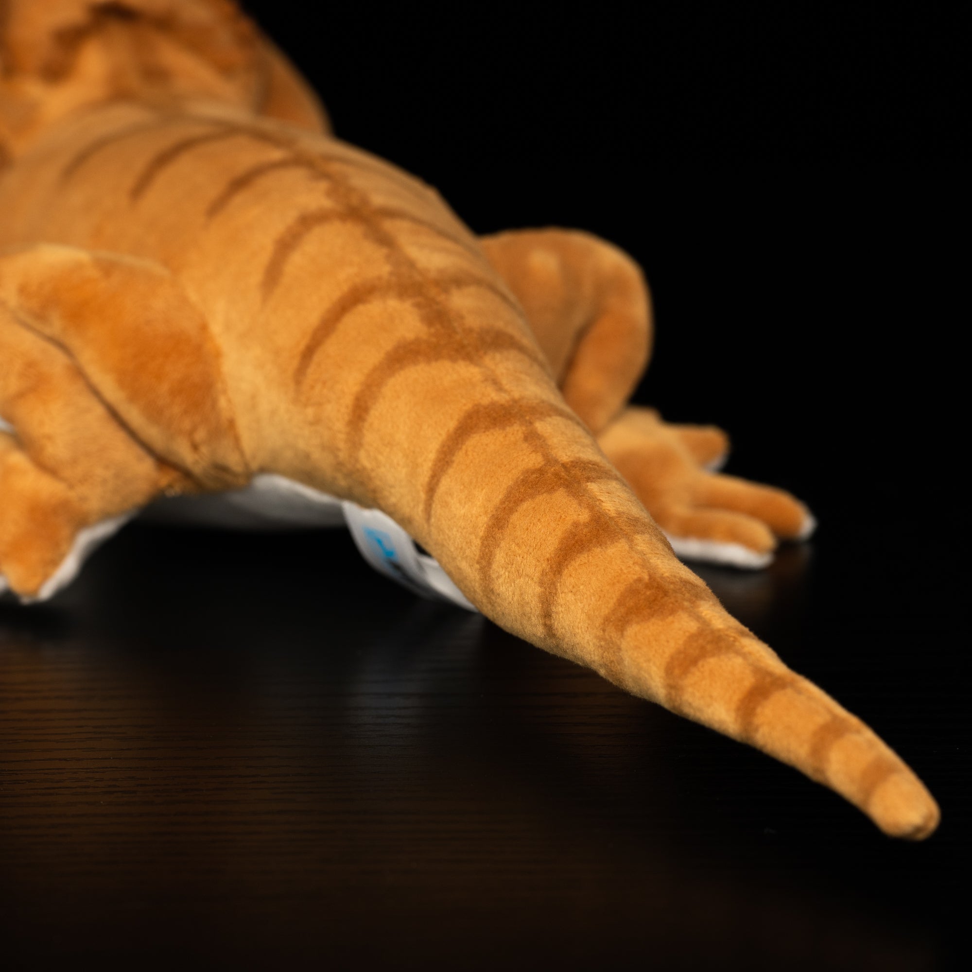 Tail close-up of realistic bearded dragon plush toy showcasing striped texture and a natural curve by SoftDaysLab
