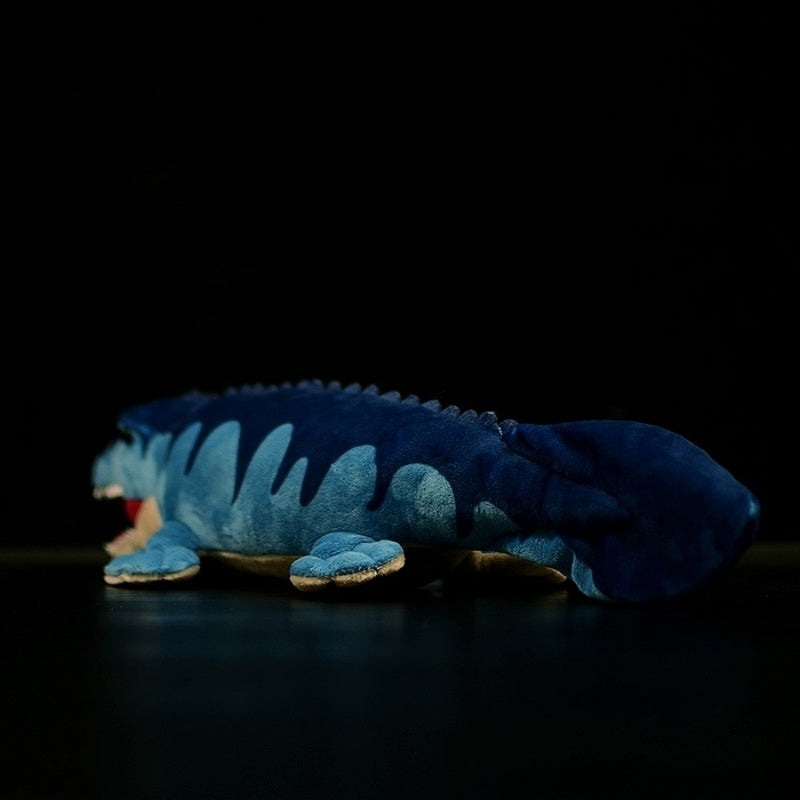 Angled rear view of Mosasaurus stuffed animal with flipper details and wavy dorsal design inspired by the sea