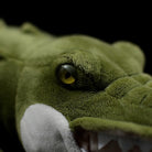 Close-up of the alligator plush's eye, showcasing its lifelike design and detailed craftsmanship