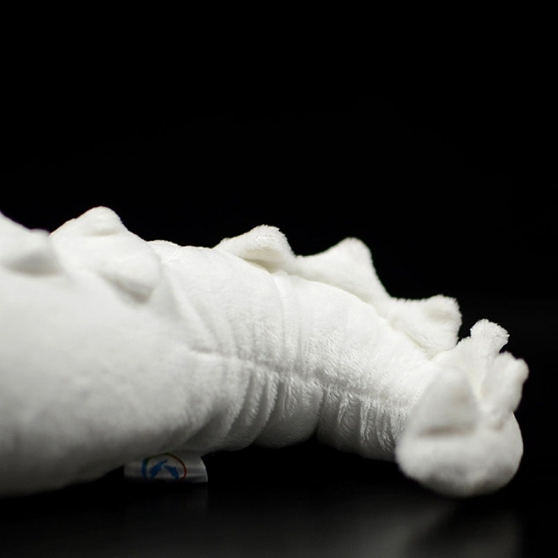 Tail close-up of albino alligator toy showcasing soft curves, spikes, and detailed texture by SoftDaysLab