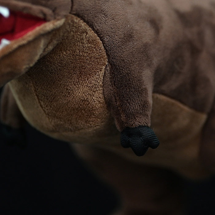 Close-up of Carnotaurus Dinosaur Plush Toy's soft arms with realistic plush texture