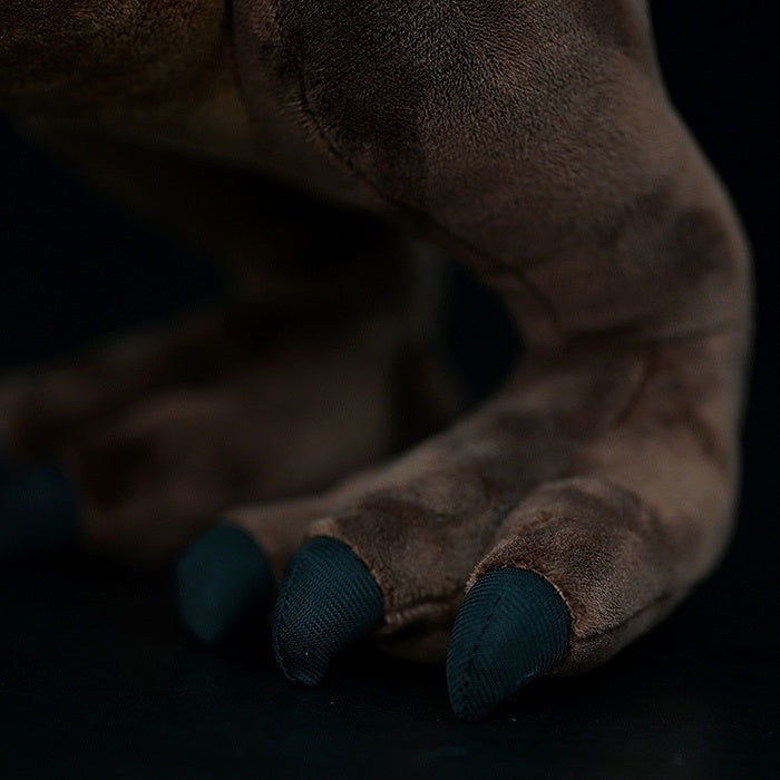 Detailed view of Carnotaurus Dinosaur Plush Toy's claws with lifelike design