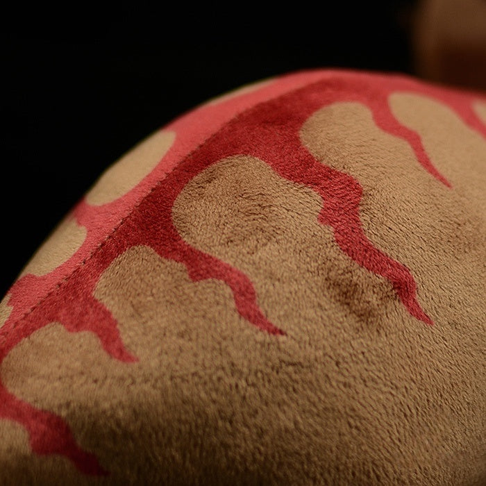 Close-up of Triceratops dinosaur plush’s body fabric with Jurassic-inspired red markings