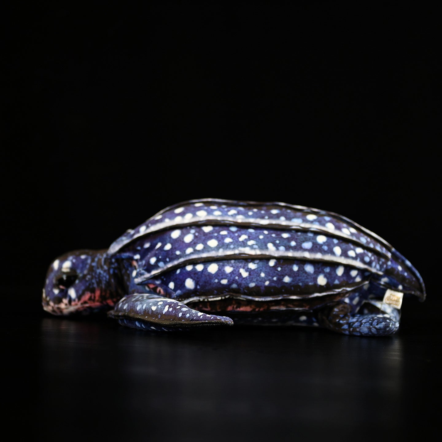 Side profile of leatherback sea turtle plush, highlighting its realistic texture and soft material