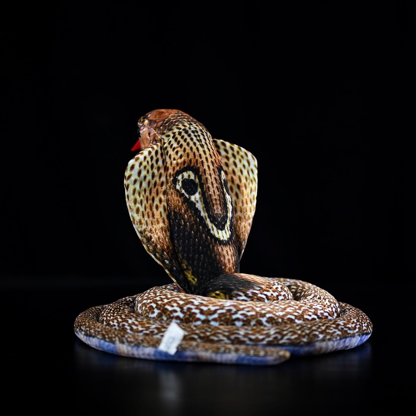 Back view of the monocled cobra plush toy highlighting the detailed hood pattern and soft texture
