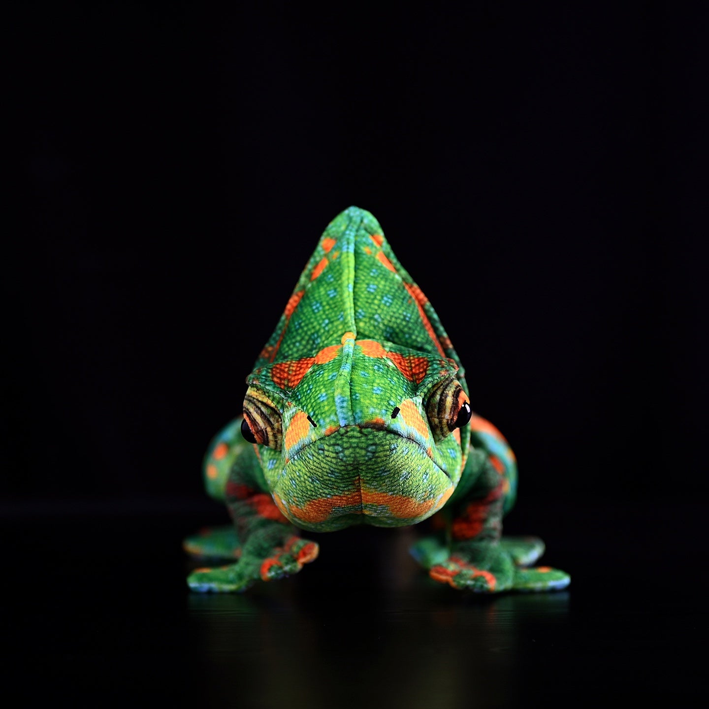Front view of a veiled chameleon plush showing detailed head structure and vibrant colors