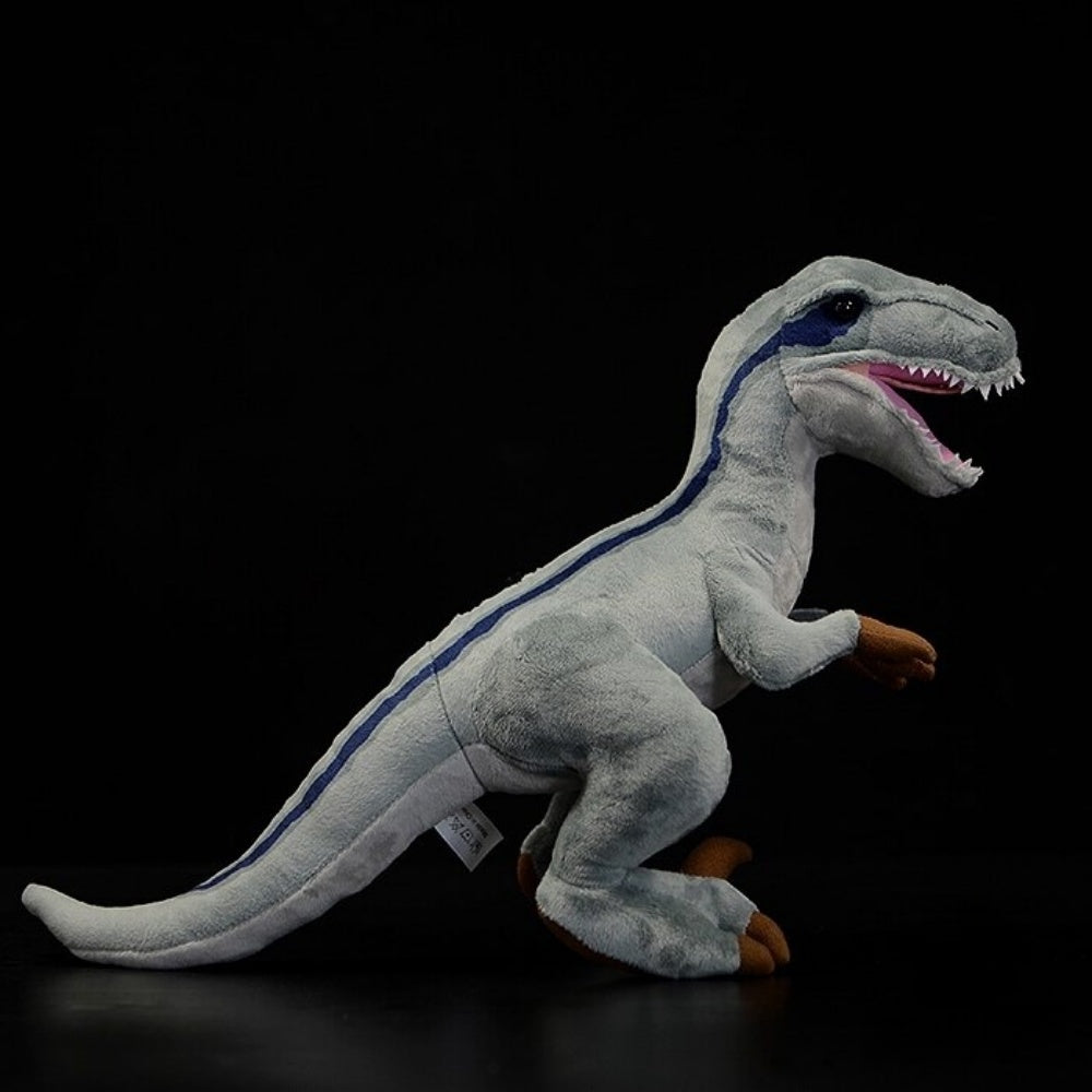 Realistic side profile of SoftDaysLab® Velociraptor plush with vibrant blue-striped detailing and fierce teeth