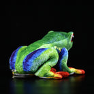 Back view of a lifelike red-eyed tree frog plush showcasing detailed green, blue, and orange patterns