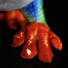Close-up of SoftDaysLab red-eyed tree frog plush's bright orange feet, highlighting its realistic craftsmanship