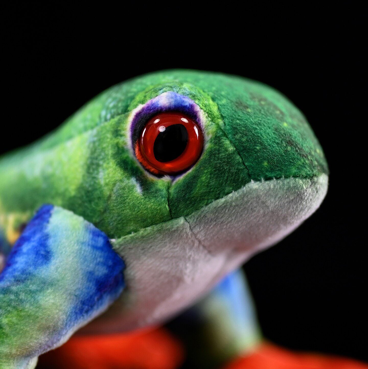 Close-up of Red-Eyed Tree Frog Plush’s realistic red eye and intricate facial details