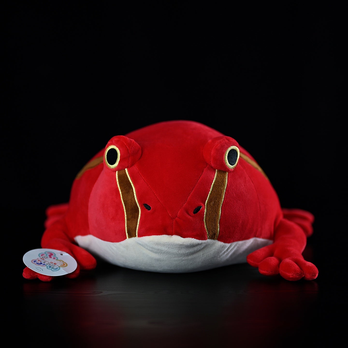 Close front view of Madagascar Tomato Frog stuffed animal, showcasing realistic detailing and soft texture