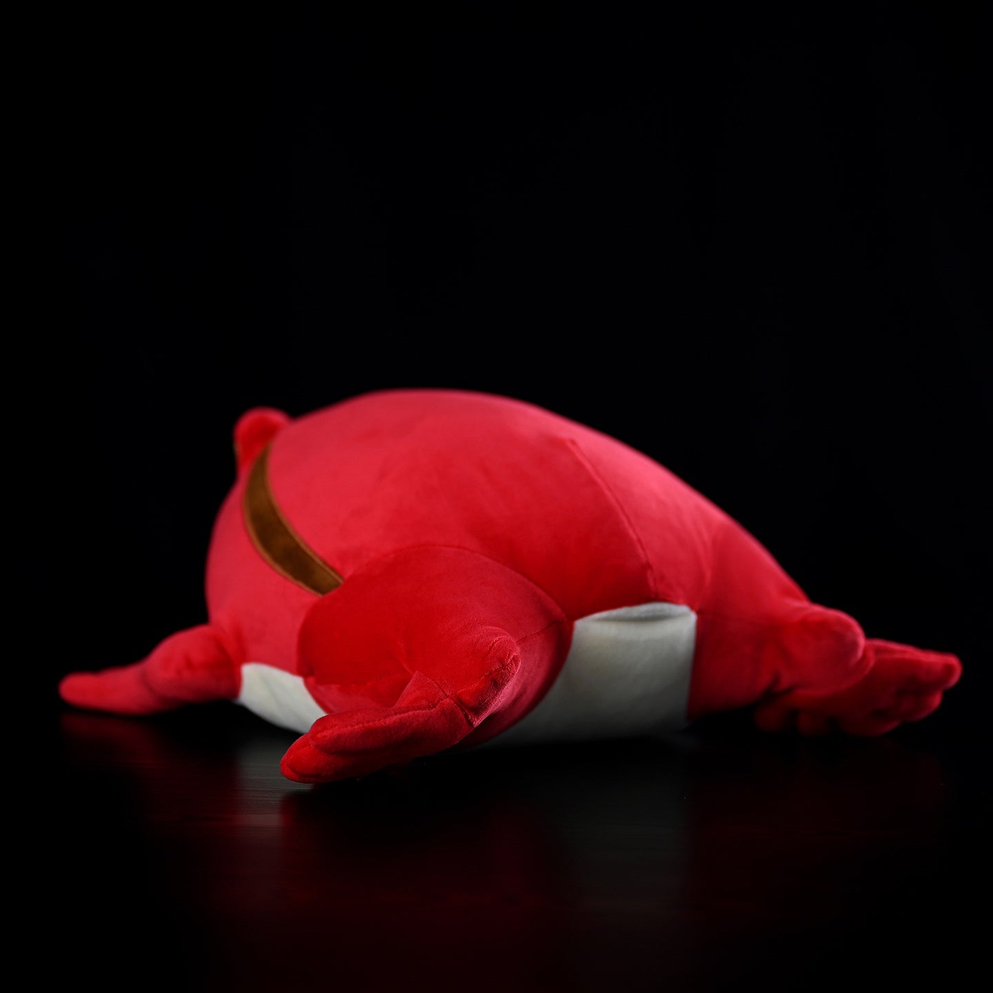 Rear view of tomato frog plush toy, highlighting its pillow-like design and smooth contours for comfort