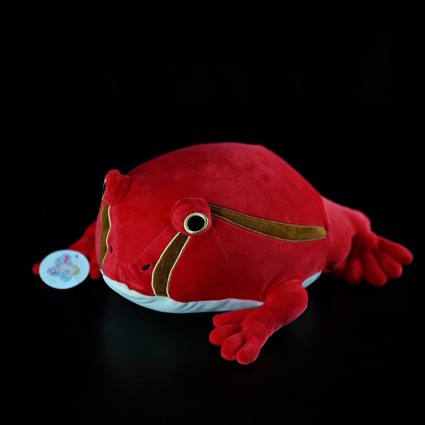 Full view of lifelike tomato frog plush toy, perfect for cuddling or displaying as a unique nature-inspired gift